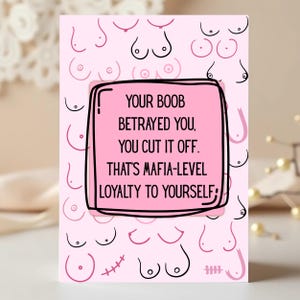 May include: A pink greeting card with a repeating pattern of stylized breasts. The card features a pink square with black text that reads: "YOUR BOOB BETRAYED YOU, YOU CUT IT OFF. THAT'S MAFIA-LEVEL LOYALTY TO YOURSELF."