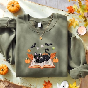 Halloween Cat Lying On Book Embroidered Sweatshirt, Halloween Bookish Cat Lover Embroidered Sweatshirt, Oversized Crew Neck Sweatshirt