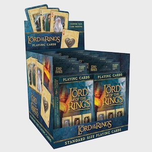 May include: A display box of "The Lord of the Rings" playing cards. The box is dark blue with the title in white and gold lettering. The cards feature custom face card designs with characters from the movie. The box reads "Standard Size Playing Cards."
