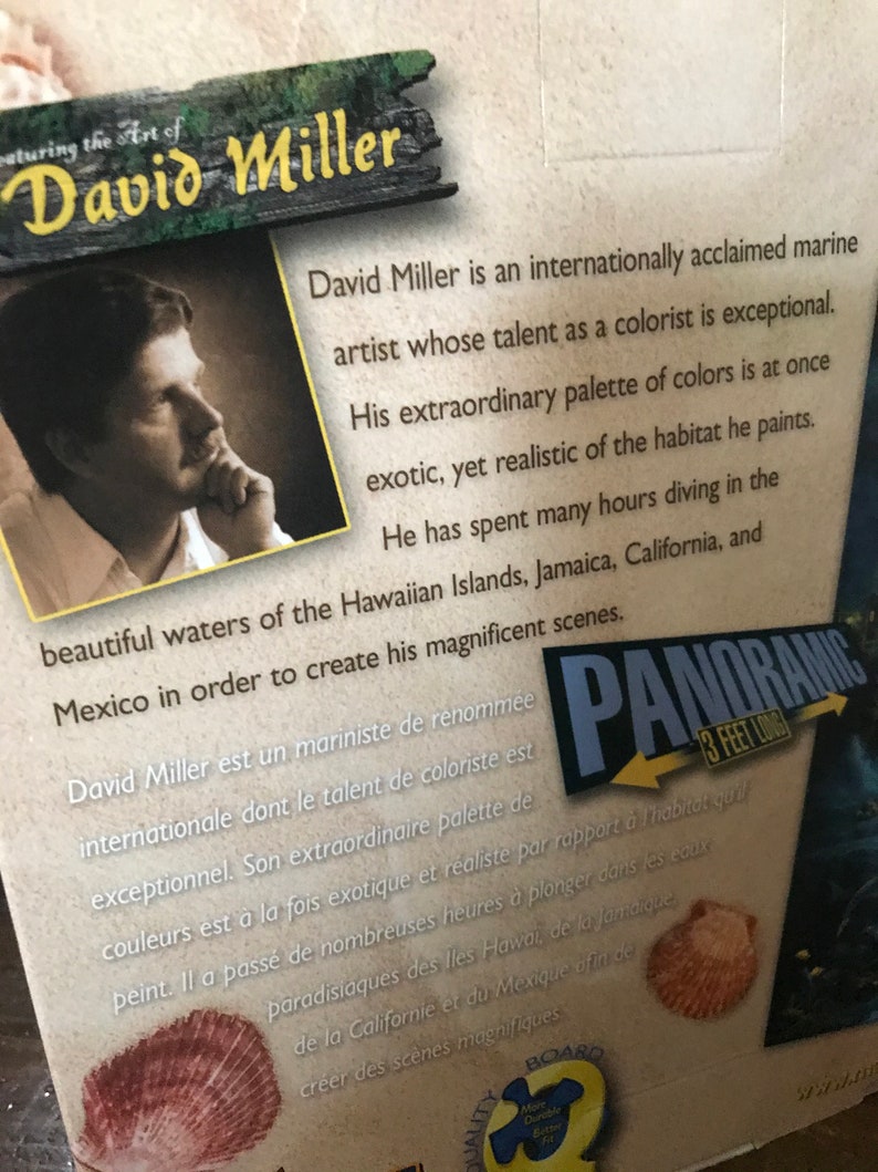 May include: A box for a 3-foot long panoramic jigsaw puzzle featuring the artwork of David Miller. The box features a portrait of the artist and text describing his work as an internationally acclaimed marine artist. The text describes his talent as a colorist and his use of color to depict the underwater world.