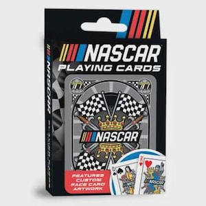 May include: A NASCAR playing cards box with a black background and the NASCAR logo in blue, red, and yellow. The box features a deck of cards with custom face card artwork. The box also has a checkered flag design.