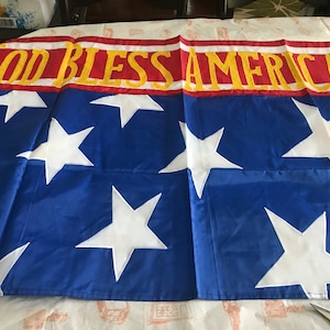 NIP God bless America outdoor yard flag - colorful red white and blue with gold letters - patriotic flag