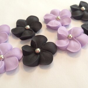 100 royal icing flowers (50 black, 50 purple) Approx. size 3/4” with sugar silver center