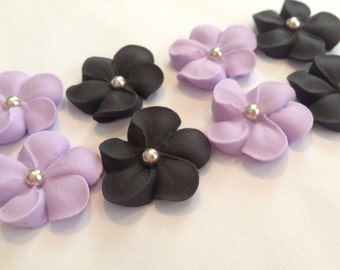 100 royal icing flowers (50 purple, 50  black) Approx. size 3/4” with silver sugar center.