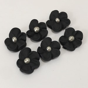 100 black royal icing flowers Approx.size 1/2” with silver sugar center