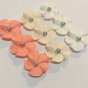 100 royal icing sugar flowers ( 34 white, 34 ivory, 34 peach) Approx. size 3/4” with silver sugar center