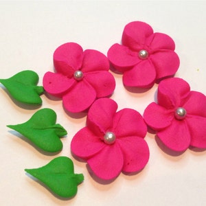 100 hot pink royal icing flowers Approx. size 3/4” with silver sugar center. Plus 50 leaves