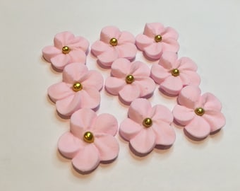 100 pink royal icing flowers Approx. size 3/4” with gold sugar center