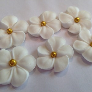 150 white royal icing flowers Approx. size 3/4” with gold sugar center