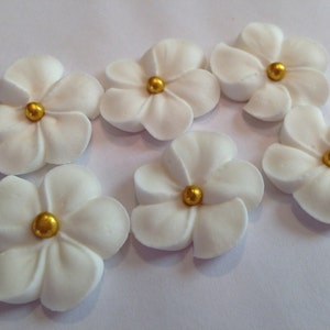 100 white royal icing flowers Approx. size 3/4” with gold sugar center