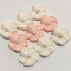 100 royal icing flowers ( 50 ivory, 50 light peach) Approx. size 1/2” with sugar pearl center