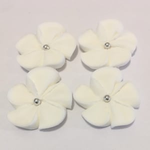 100 white royal icing flowers Approx. size 1” with silver sugar center