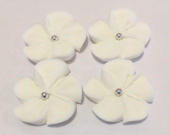 100 white royal icing flowers Approx. size 1” with silver sugar center
