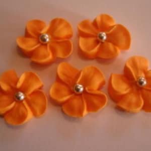 100 orange royal icing flowers Approx. size 3/4” with silver sugar center
