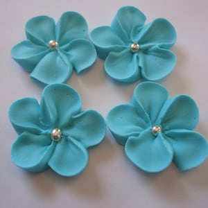100 teal royal icing flowers Approx. size 1” with silver sugar center