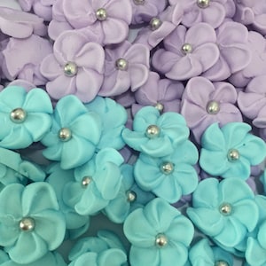 100 royal icing flowers ( 50 light purple and 50 light blue teal) Approx.size 1/2” with silver sugar center