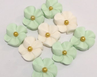 100 royal icing flowers ( 50 ivory and 50 green) Approx. size 3/4” with gold sugar center