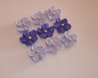 100 royal icing flowers (50 light 50 dark purple) Approx. size 3/4” with silver sugar center