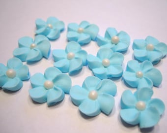 100 blue royal icing flowers Approx. size 3/4” with pearl sugar center