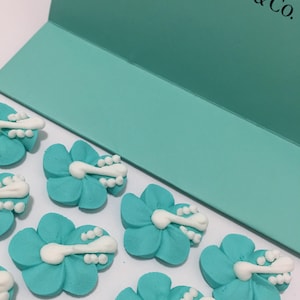 100 teal hibiscus royal icing flowers Approx. size 3/4”