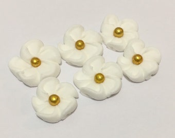 100 white royal icing flowers Approx.size 1/2” with gold sugar center