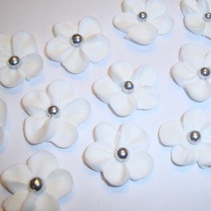 100 white royal icing flowers Approx. size 3/4” with sugar silver center