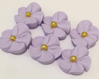 100 light purple royal icing flowers Approx. size 3/4” with gold sugar center