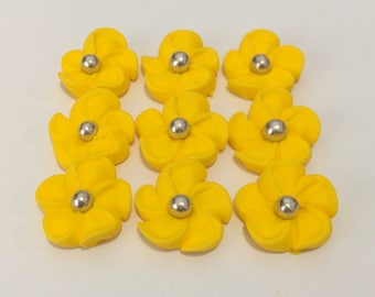 100 yellow royal icing flowers Approx.size 1/2” with silver sugar center