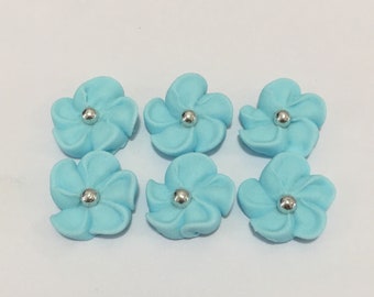 100 blue royal icing flowers Approx.size 1/2” with silver sugar center