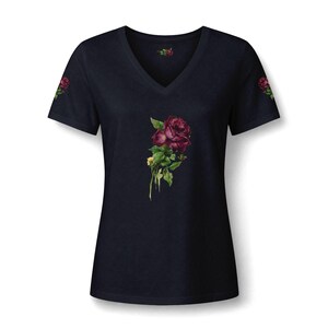 May include: A dark navy blue V-neck t-shirt featuring a detailed graphic of a deep red rose with green leaves centered on the chest. Smaller matching rose graphics are positioned on the outer edge of each short sleeve, and a tiny rose icon is printed inside the neckline.