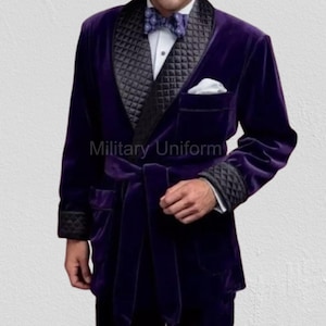 May include: A deep purple velvet robe with a black quilted shawl collar and cuffs. The robe has a matching belt, pockets, and the text "Military Uniform" printed on the front.