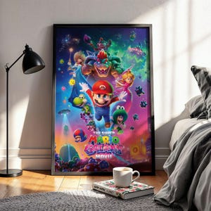 May include: Framed poster featuring characters from The Super Mario Galaxy Movie. Mario is in the center, wearing a red cap and blue overalls, surrounded by other characters against a colorful, space-themed background. The movie title is displayed in pink and blue.