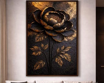 May include: A framed wall art piece featuring a large, stylized flower in shades of black and gold. The flower has detailed petals and leaves, with a textured appearance. The artwork is set against a dark background, creating a striking contrast.