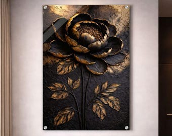 May include: A large, textured wall art piece featuring a stylized black and gold flower. The flower has detailed petals and leaves, with a dark background. The artwork is mounted on a clear panel with silver hardware, creating a modern, elegant look.