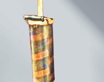 May include: A vertical metal tool featuring a cylindrical body with alternating horizontal bands of metallic gold and dark tones. It has a long, thin rod extending from the top and a smaller, conical base section with a horizontal handle at the bottom.