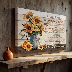 May include: A canvas print featuring a rustic design with sunflowers and hummingbirds. The artwork includes a blue vase with a cross and the text "I still Believe in Amazing Grace...The old Rugged Cross."