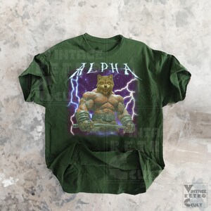 May include: Green t-shirt with a graphic of a muscular wolf with lightning bolts and the word "ALPHA" in a metal font.