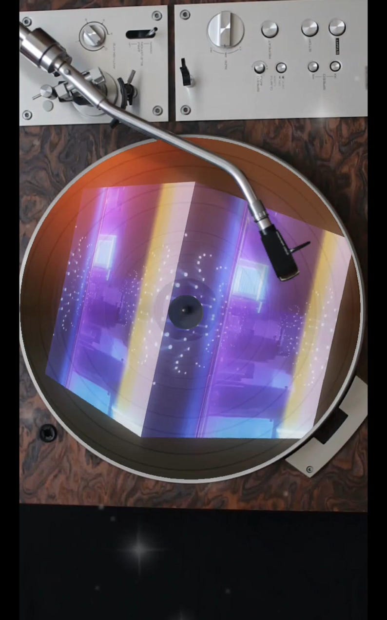 May include: A vintage record player with a turntable and a tonearm. The turntable is playing a record with a holographic design that appears to be a cube with a purple, blue, and yellow color scheme.