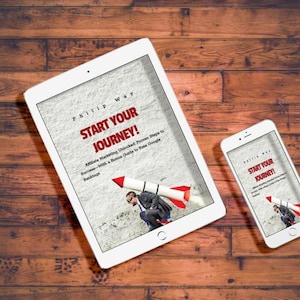 May include: A white tablet and smartphone displaying the book cover "Start Your Journey!" on a wooden surface. The book cover features a man with a rocket strapped to his back. The background is a light gray texture.