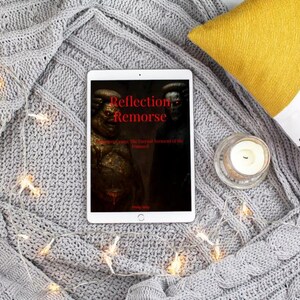 May include: A tablet displaying the book cover "Reflection Remorse" rests on a gray knitted blanket. The cover features a dark, artistic image with red text. A lit candle and decorative lights are also present.