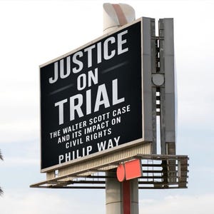 May include: An outdoor billboard displaying the words "JUSTICE ON TRIAL" in white against a black backdrop. The text below reads "THE WALTER SCOTT CASE AND ITS IMPACT ON CIVIL RIGHTS PHILIP WAY".