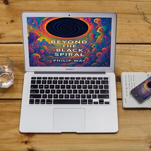 May include: A laptop displays the book cover "Beyond the Black Spiral" by Philip Way, featuring a colorful, abstract design. A glass of water, a notebook, and a smartphone with a matching design are on a wooden surface.