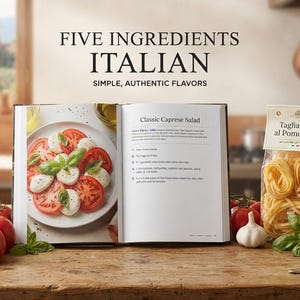 May include: A cookbook titled FIVE INGREDIENTS ITALIAN SIMPLE, AUTHENTIC FLAVORS is open to a page showing a Caprese salad. Beside it sits a package of Tagliatelle al Pomodoro, fresh red tomatoes, a head of garlic, basil, and a bottle of olive oil.