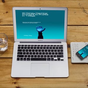 May include: A silver laptop displays a teal screen with the text "AI Money Machine: Prompts to Profits in 7 Days." A smartphone and notebook sit nearby on a wooden surface. A glass of water is also present.