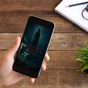May include: A smartphone displaying a dark, atmospheric digital image of a silhouette standing in a forest with mushrooms. The text on the screen reads Death Cap Delusions: The Erin Patterson Case Unveiled in red lettering against the dark background.