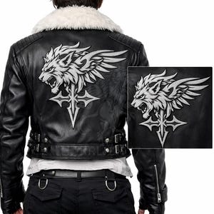 May include: Black leather jacket with a white faux fur collar and a silver wolf and cross design on the back. The jacket has a cropped style, with silver zippers and buckles. A smaller version of the design is on the right.