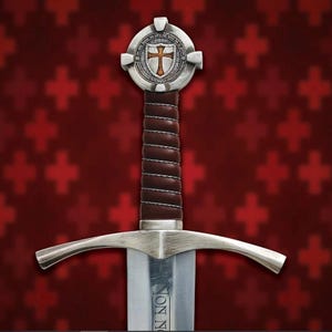 May include: A medieval sword with a silver blade and guard, featuring a brown leather-wrapped handle. The pommel is a silver disc with a cross emblem. The background is a red pattern of crosses.