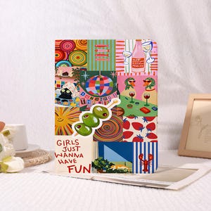 May include: A rectangular tablet case featuring a vibrant collage of illustrations including a disco ball, a black cat, two geese with wine glasses, strawberries, a lobster, and three olives on a pick. The text reads "GIRLS JUST WANNA HAVE FUN".