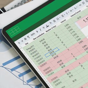 May include: A digital tablet displaying a spreadsheet with columns for date, new contribution, and number of days. The screen shows numerical data in rows with alternating white, light green, and light red cells, alongside a paper pie chart.