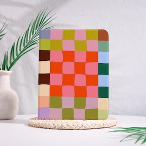 May include: A rectangular tablet case featuring a vibrant, wavy checkerboard pattern in various colors including orange, pink, olive green, brown, light blue, and lavender. The design covers the entire front surface of the protective cover.